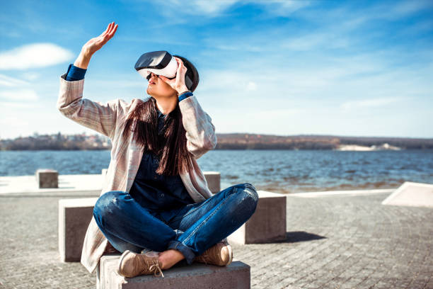 istock Woman in virtual reality glasses outdoor 673376402