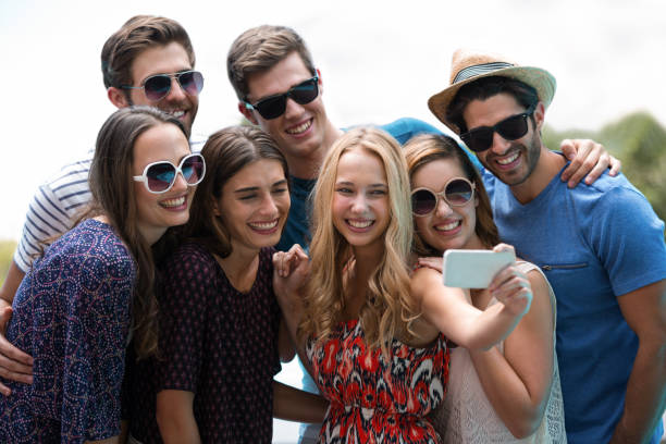 istock Happy friends taking a selfie near swimming pool 673378982