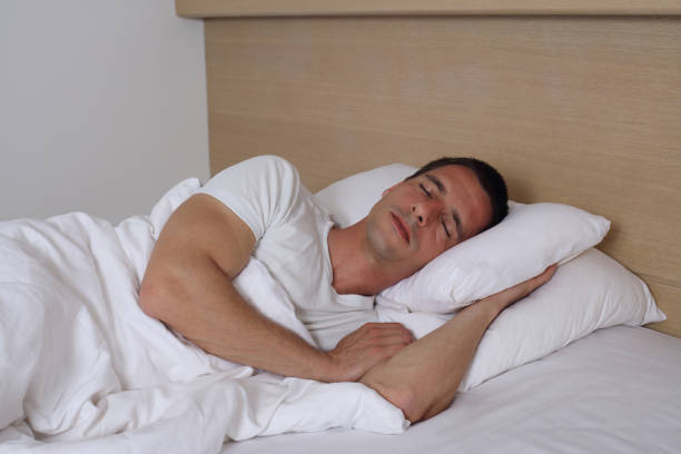 istock Young handsome man sleeping comfortably in bed. 673379796