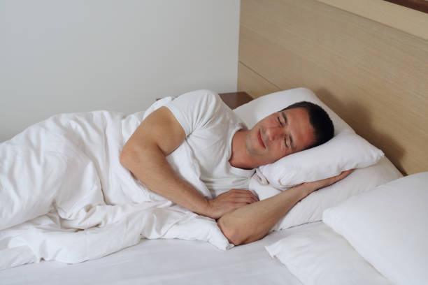 istock Young handsome man sleeping comfortably in bed. 673379836