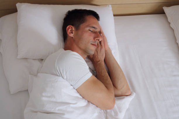 istock Young handsome man sleeping comfortably in bed. 673379904