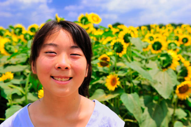 istock Girl with sunflowers 673386282