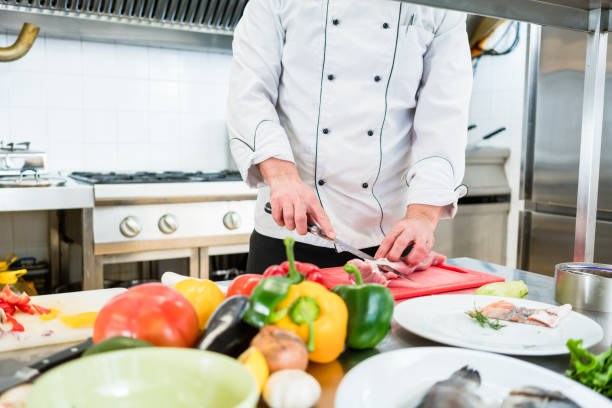 istock Chef cutting onions and vegetable to prepare for cooking 673388382