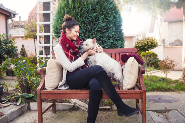 istock Beautiful young woman with dog 673393290