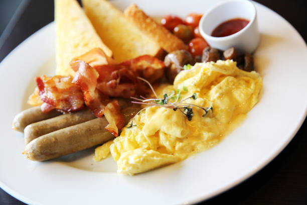 istock American Breakfast with bacon , scrambled egg on wood background 673395186