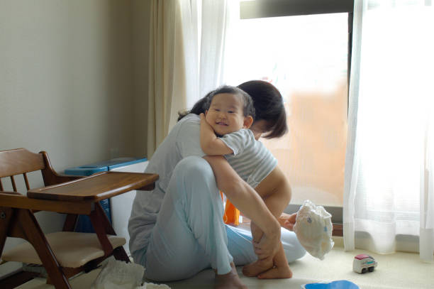 istock Mother and baby changing diaper 673396286