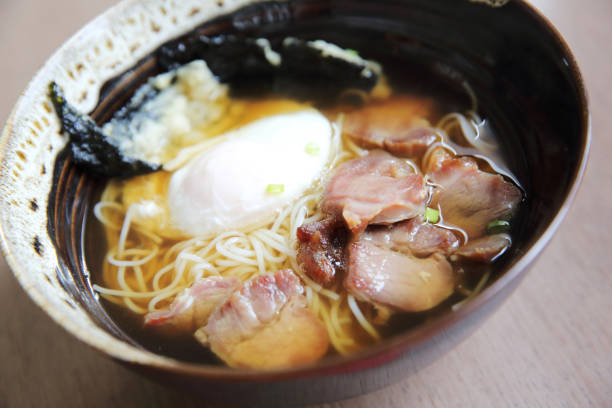istock Noodle with pork and egg on wood background 673397330