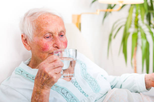 istock Senior woman drinking water 673400224