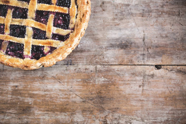 istock Fresh Cherry Pie with a Flaky Crust On Wooden Table 673400750