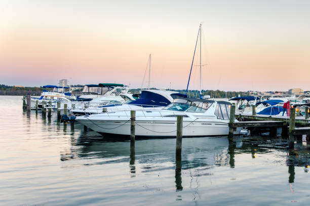 yachts tied up to a jetty on the potomac river at dusk - moored boats imagens e fotografias de stock