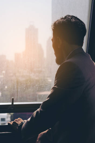istock Stressed business man standing by the window. 673402810
