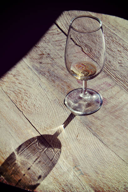 istock empty glass on brown wooden background 673405036