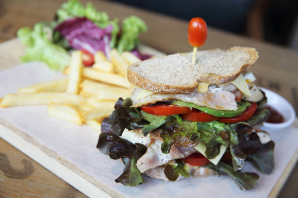 istock Club sandwich with on wood background 673405450