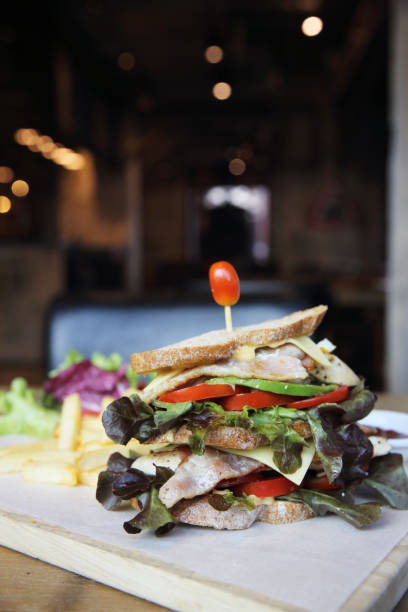 istock Club sandwich with on wood background 673405456
