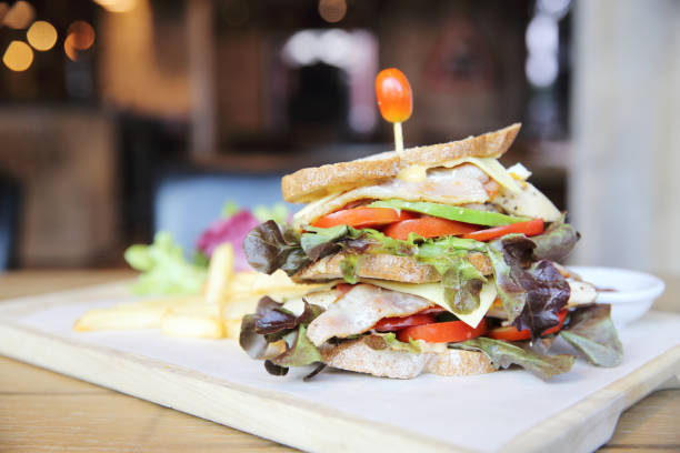 istock Club sandwich with on wood background 673405468