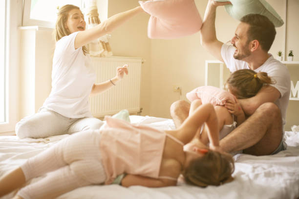istock Happy family having fun on bed. 673405564