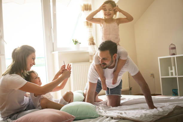 istock Happy family with two daughters at home. 673405698