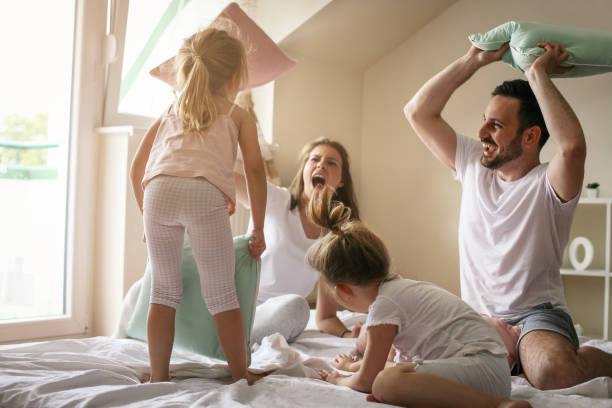 istock Happy family having fun on bed. 673405898