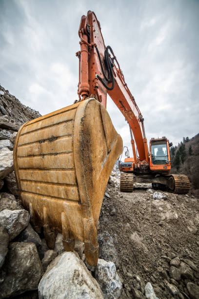 istock excavator is making pile of soil by pulling ground up on heap at construction site, project in progress 673406074
