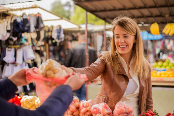 istock Woman shopper selecting fresh potatoes 673410890