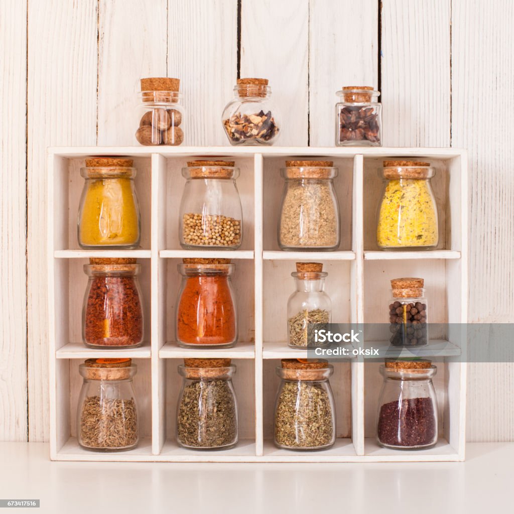 Still life with spices Assortment of dry spices in vintage glass bottles in wooden box Spice Stock Photo