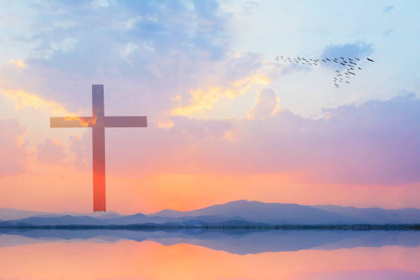 istock cross against mountain and lake view at sunset 673417618