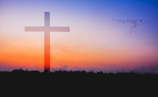 istock cross against mountain and lake view at sunset 673418392