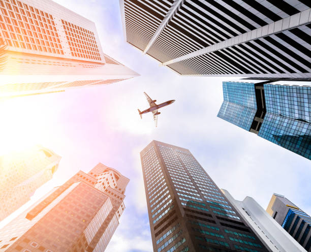 istock Business towers and aircraft 673425842