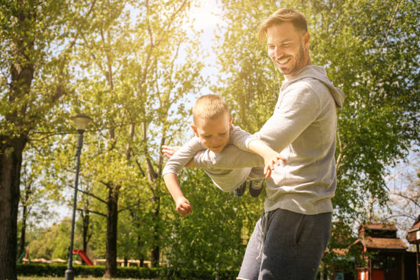 istock Father and son playing on the meadow. 673431108