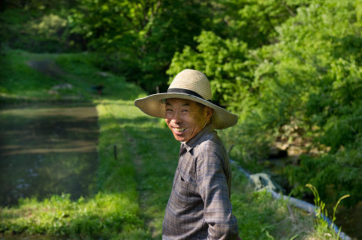 Old man with a smile in rice field