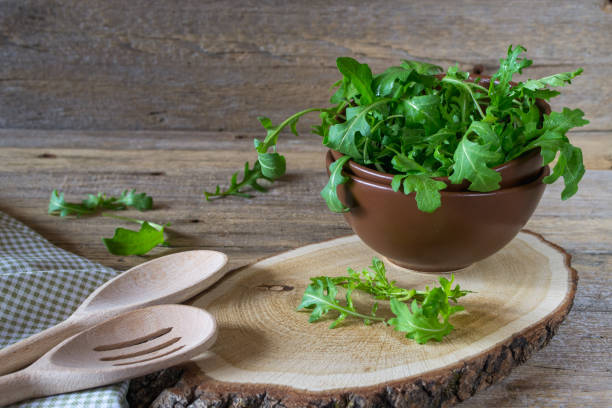 istock Fresh garden organic arugula, ruccola  in bowl  on rustic background ready for salad. 673442116