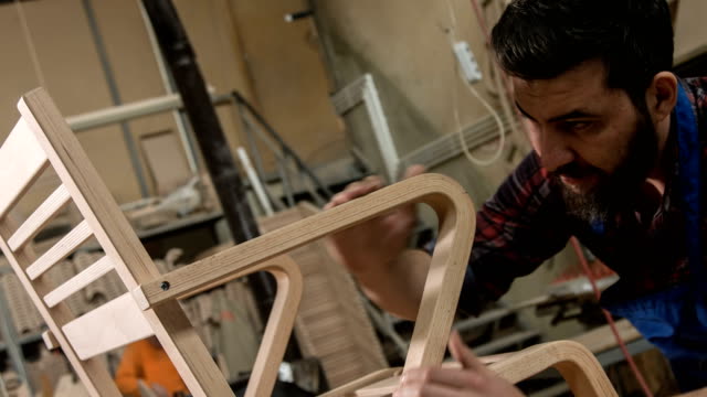 Carpenter Examining The Chair