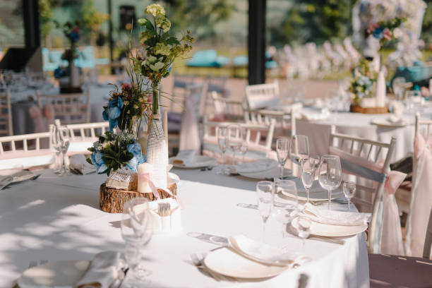 istock Wedding table decoration with candles and rose bouquets 673449570