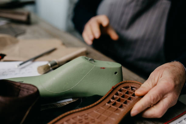 istock Senior cobbler making handmade shoes 673452246