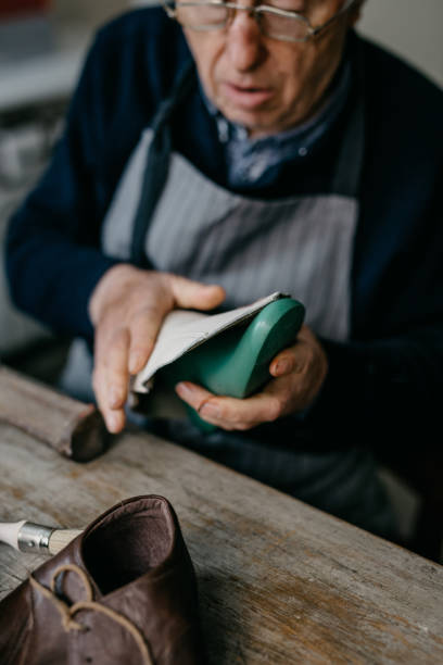istock Senior cobbler working at the shop 673456774