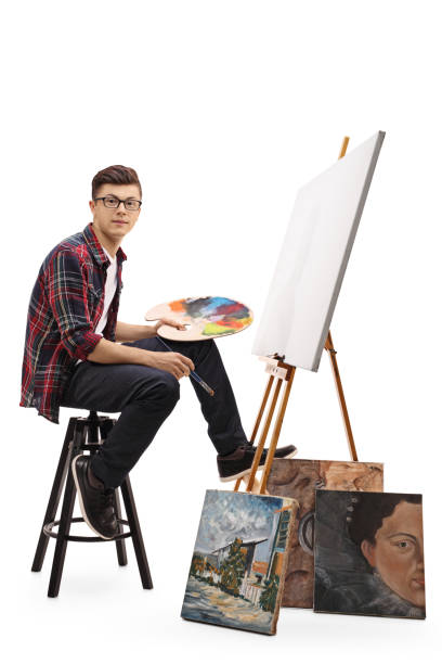 istock Teenage painter sitting in front of a blank canvas 673464794
