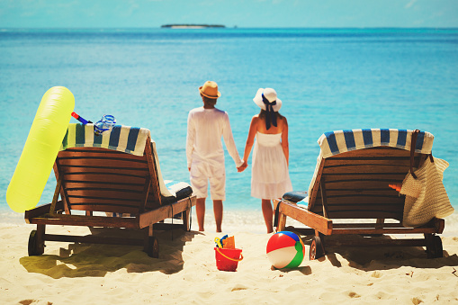 happy couple relax on a tropical sand beach
