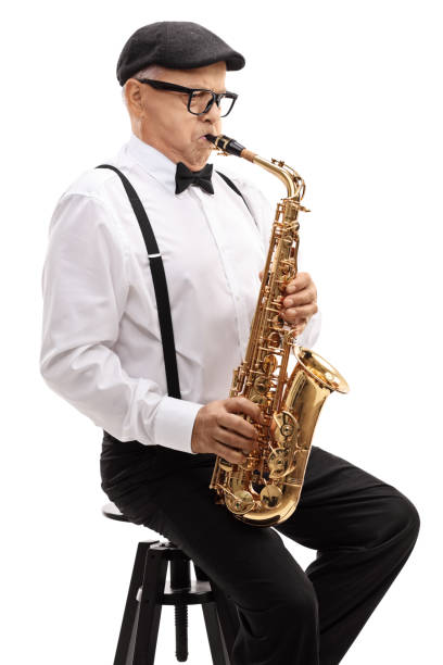 istock Elderly saxophonist sitting on a chair and playing 673465456