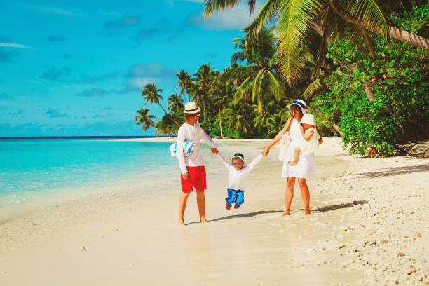istock family with kids playing walking on tropical beach 673468494