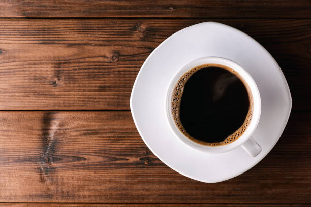 istock Coffee cup with saucer on wooden table. 673469024