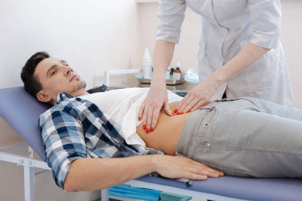 istock Handsome nice man being examined by the doctor 673474290