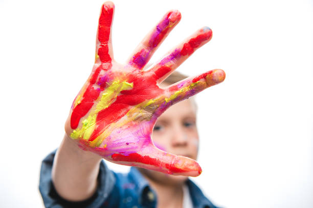 istock Excited schoolboy artist 673478420