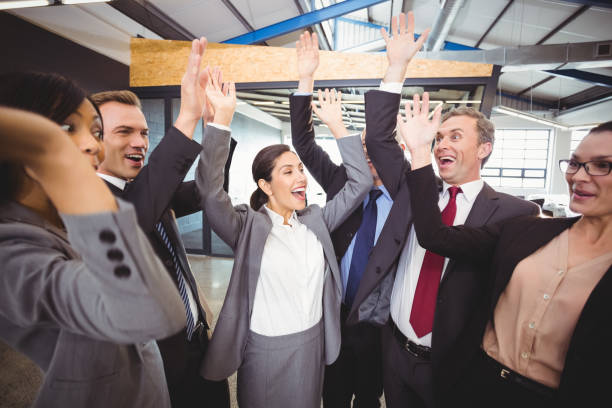 istock Cheerful businesspeople raising hands 673480254