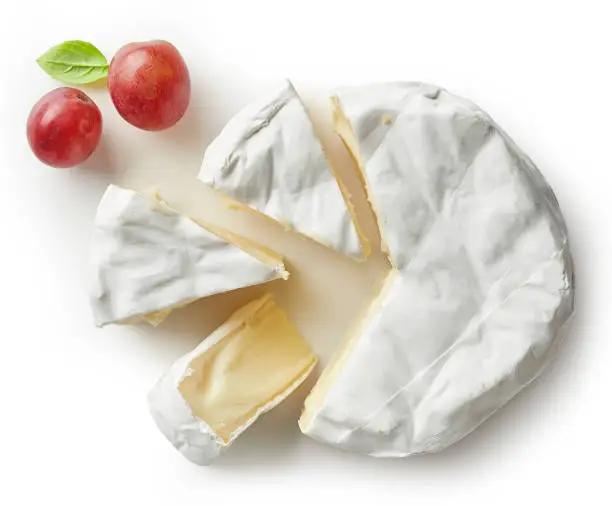 Piece of camembert cheese isolated on white background. From top view