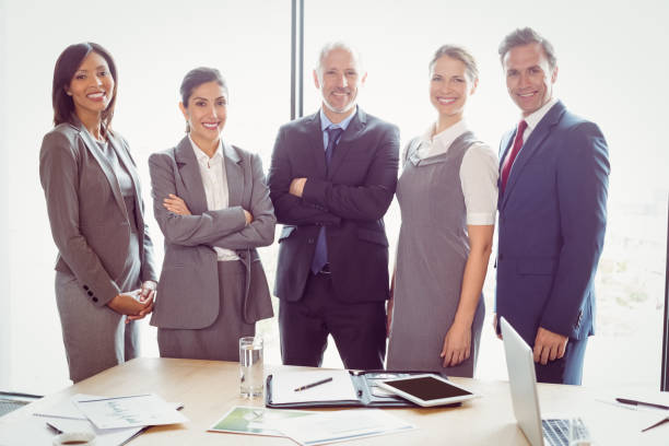 istock Businesspeople standing together in conference room 673480446