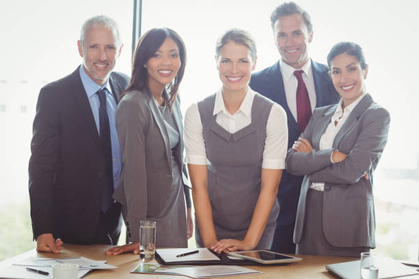 istock Businesspeople standing together in conference room 673480768