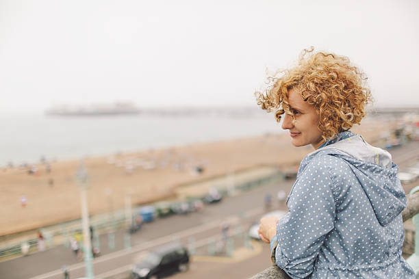 istock Woman Looking At Sea Against Clear Sky 673483599