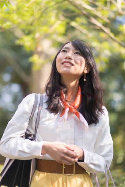 istock Young woman walking in fresh green forest 673484620