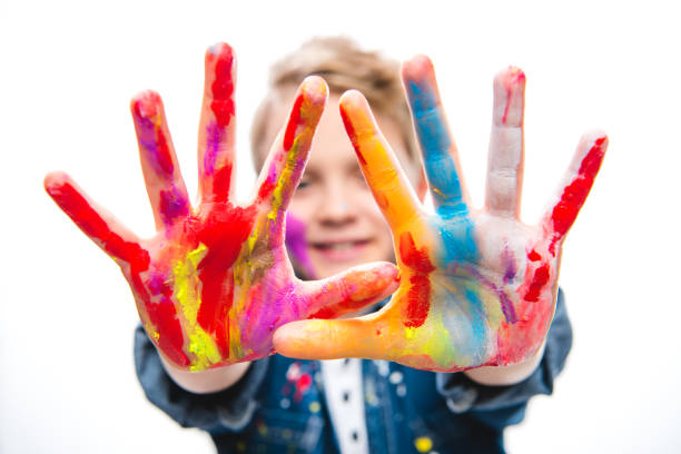 istock Excited schoolboy artist 673485222