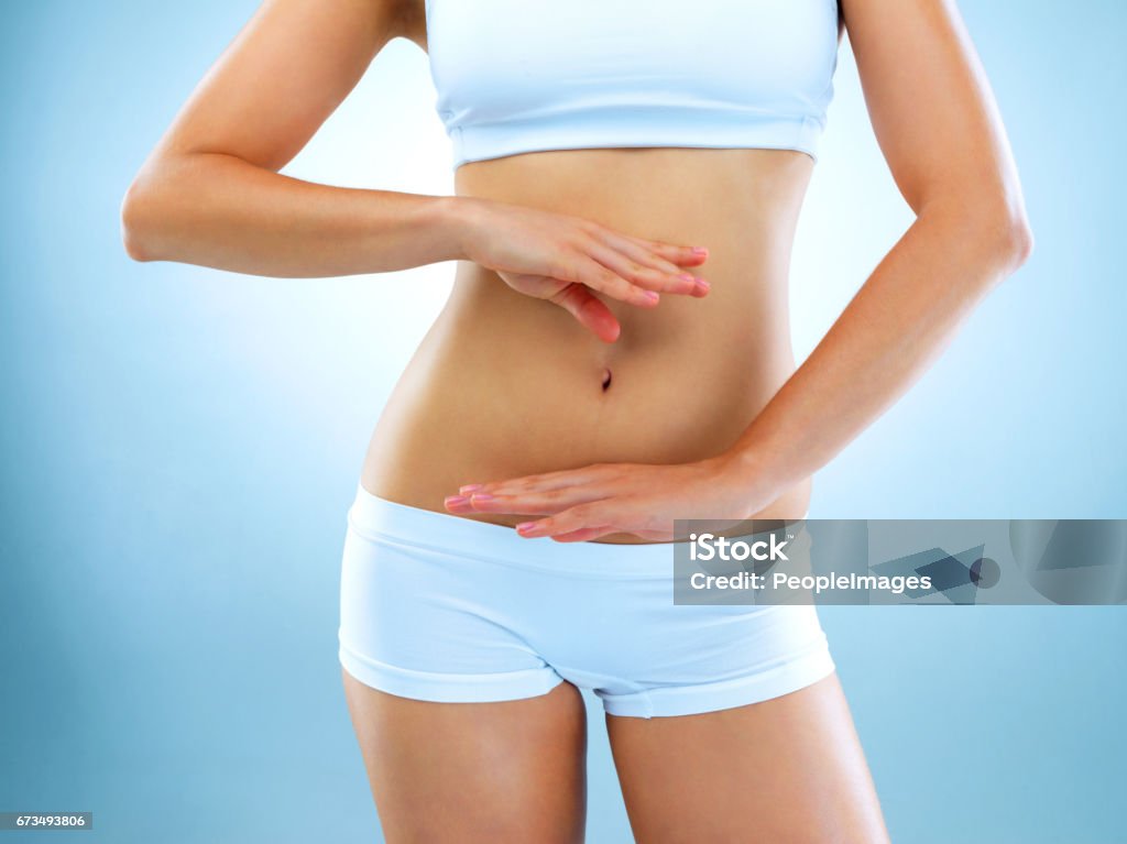 Keeping Her Tummy Tight And Toned Stock Photo - Download Image Now -  Abdomen, Women, Flat - Physical Description - iStock